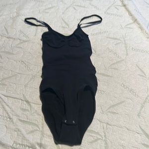 Body shaper body suit with snap closure at crotch.